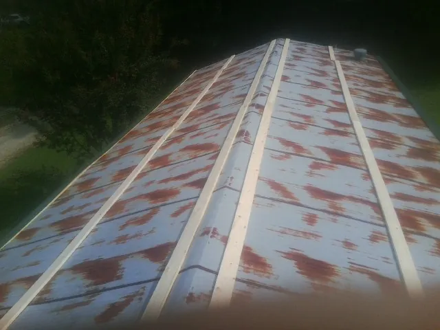 Rusted metal roof panels with new wood purlins before replacement — Storm Damage Roof Repair in Krotz Springs by Roofing Brothers